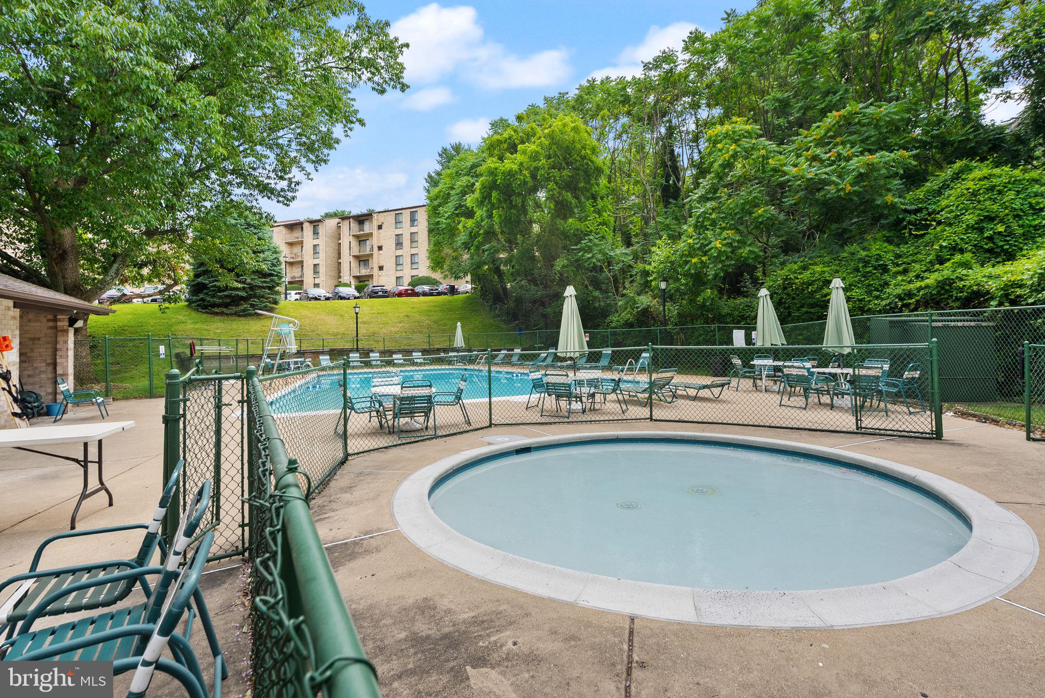 6137 Edsall Road, Unit L Alexandria, VA 22304 - Photo 34 of 36 a swimming pool with outdoor seating and yard