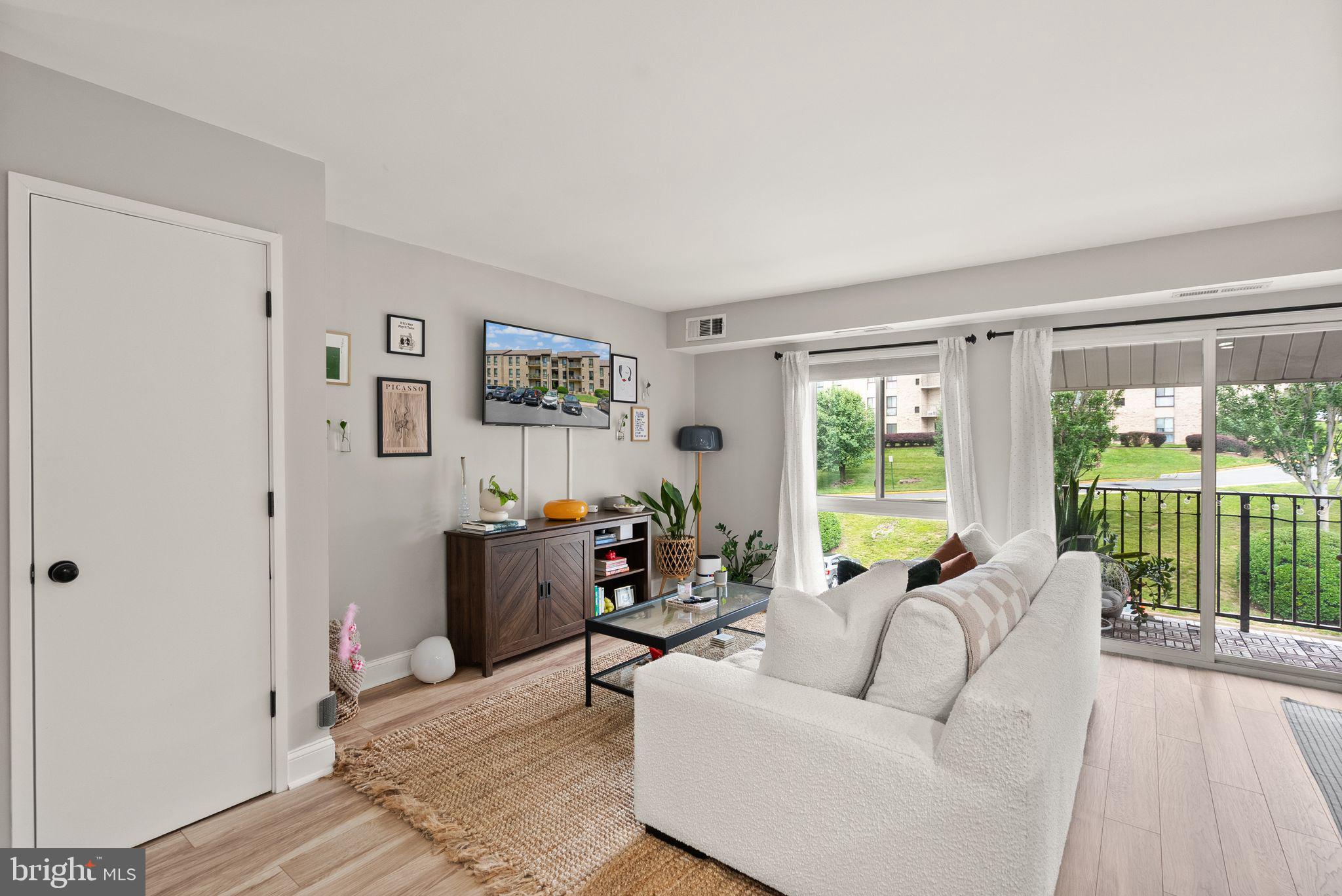 6137 Edsall Road, Unit L Alexandria, VA 22304 - Photo 7 of 36 a living room with furniture and large windows