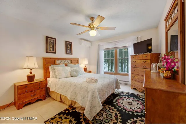 a bedroom with a bed dresser and a window