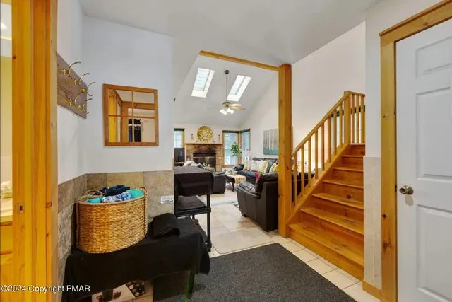 a living room with furniture and a floor to ceiling window
