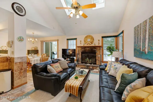a living room with fireplace furniture and a flat screen tv