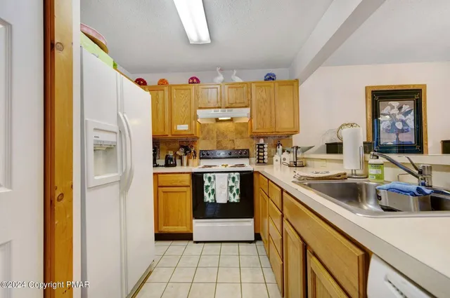 a kitchen with stainless steel appliances a refrigerator sink and cabinets