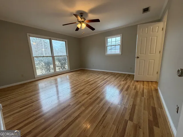 wooden floor in an empty room with a window