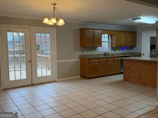 a large kitchen with cabinets and window