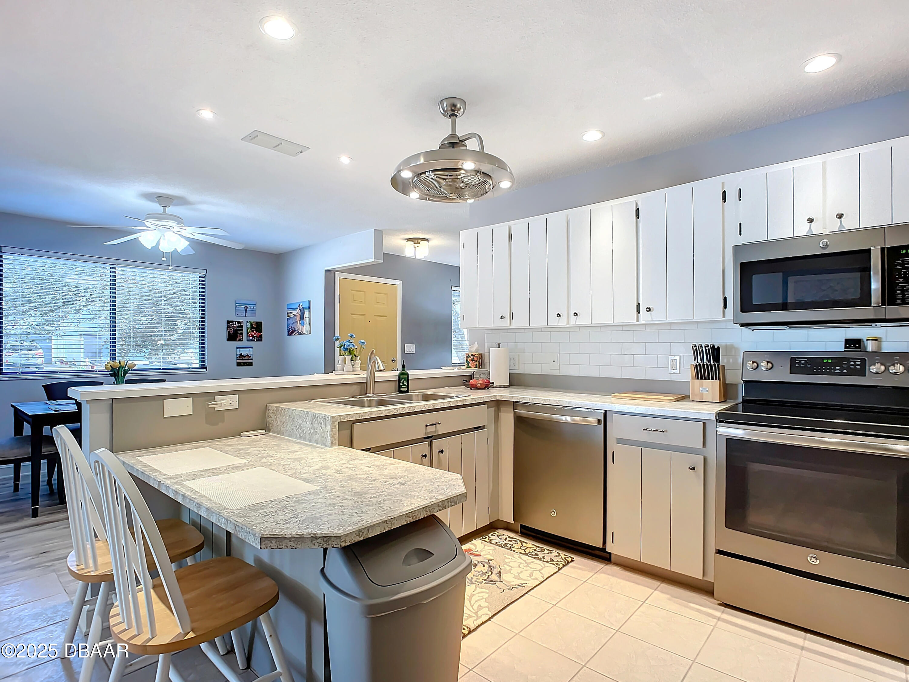 39 Crooked Pine Road Port Orange, FL 32128 - Photo 19 of 47 a kitchen with a stove a sink a dining table and chairs