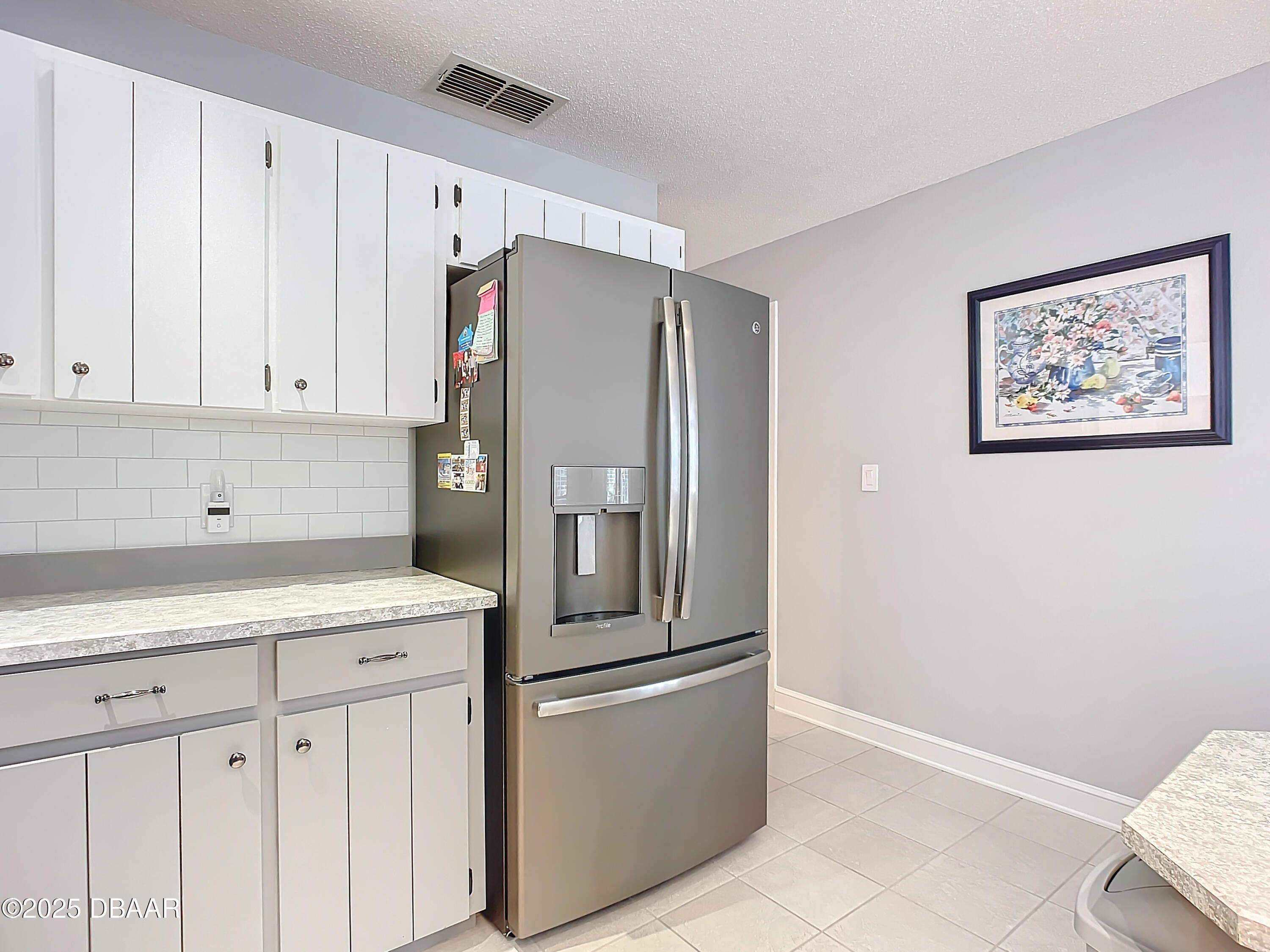 39 Crooked Pine Road Port Orange, FL 32128 - Photo 22 of 47 a kitchen with stainless steel appliances a refrigerator and cabinets