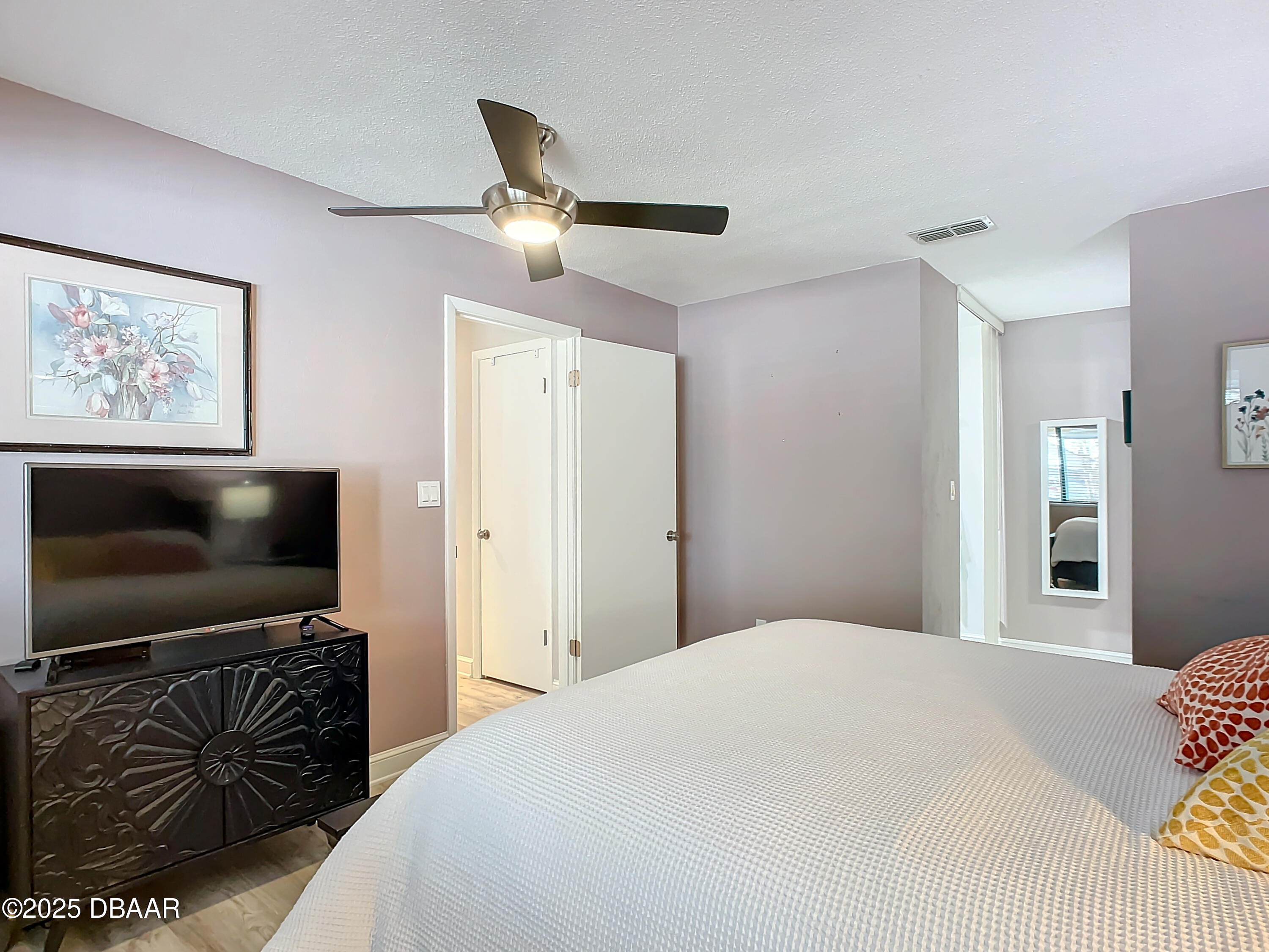 39 Crooked Pine Road Port Orange, FL 32128 - Photo 26 of 47 a bedroom with a flat screen tv and a bed