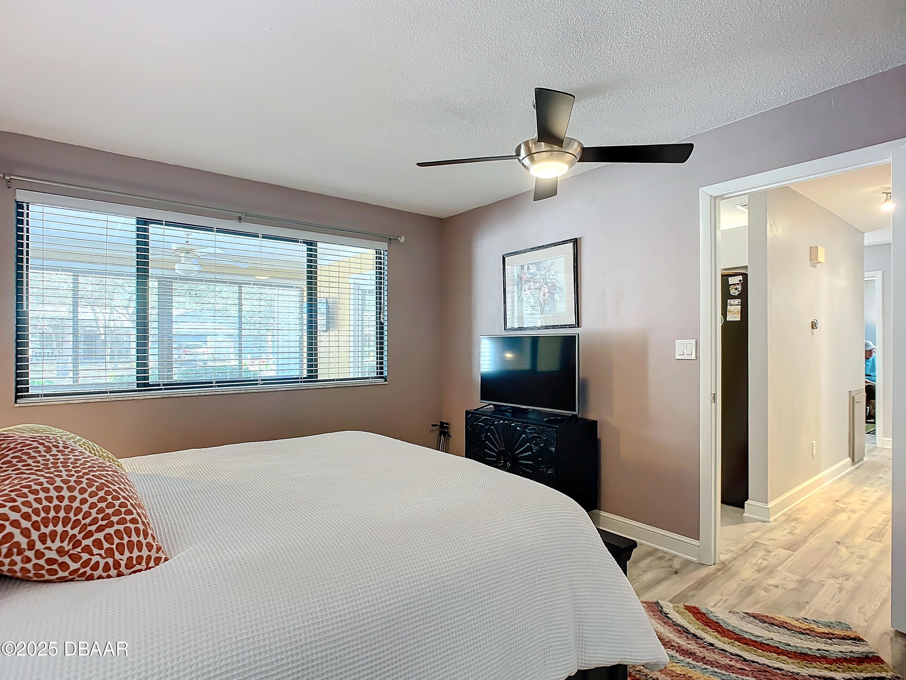 39 Crooked Pine Road Port Orange, FL 32128 - Photo 27 of 47 a bedroom with a bed and wooden floor