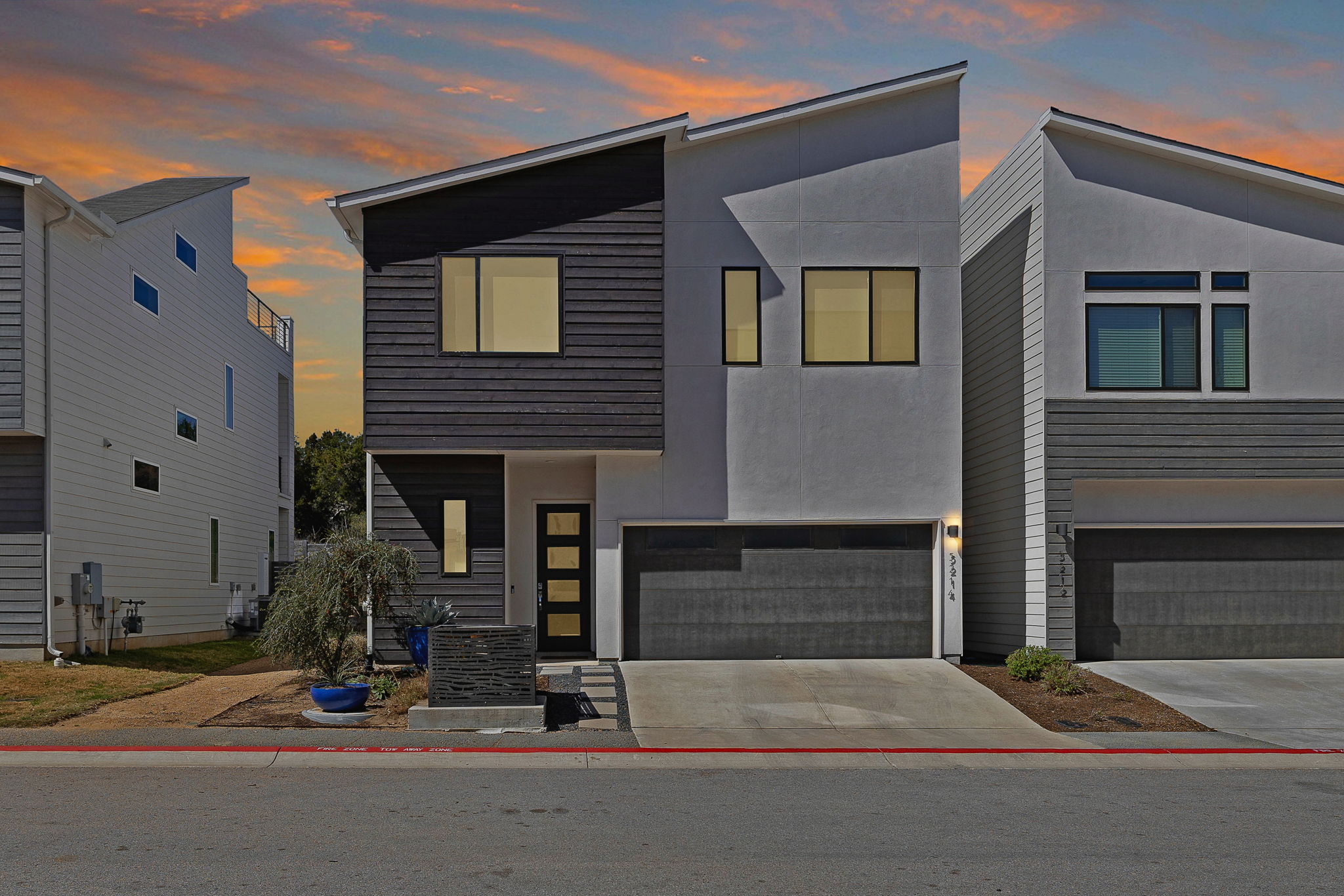 5214 Pink Poppy Pass Austin, TX 78735 - Photo 2 of 34 Contemporary home with stucco siding, an attached garage, and concrete driveway