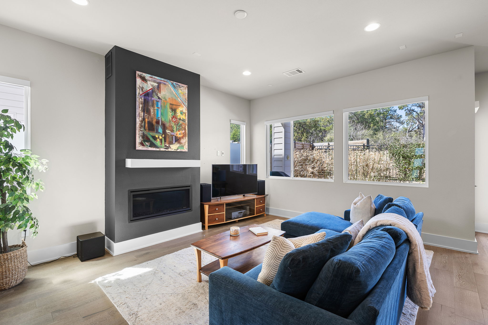 5214 Pink Poppy Pass Austin, TX 78735 - Photo 6 of 34 Living room featuring a glass covered fireplace, light wood finished floors, and recessed lighting