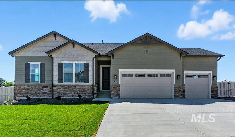 Craftsman-style home with stone siding, an attached garage, and driveway