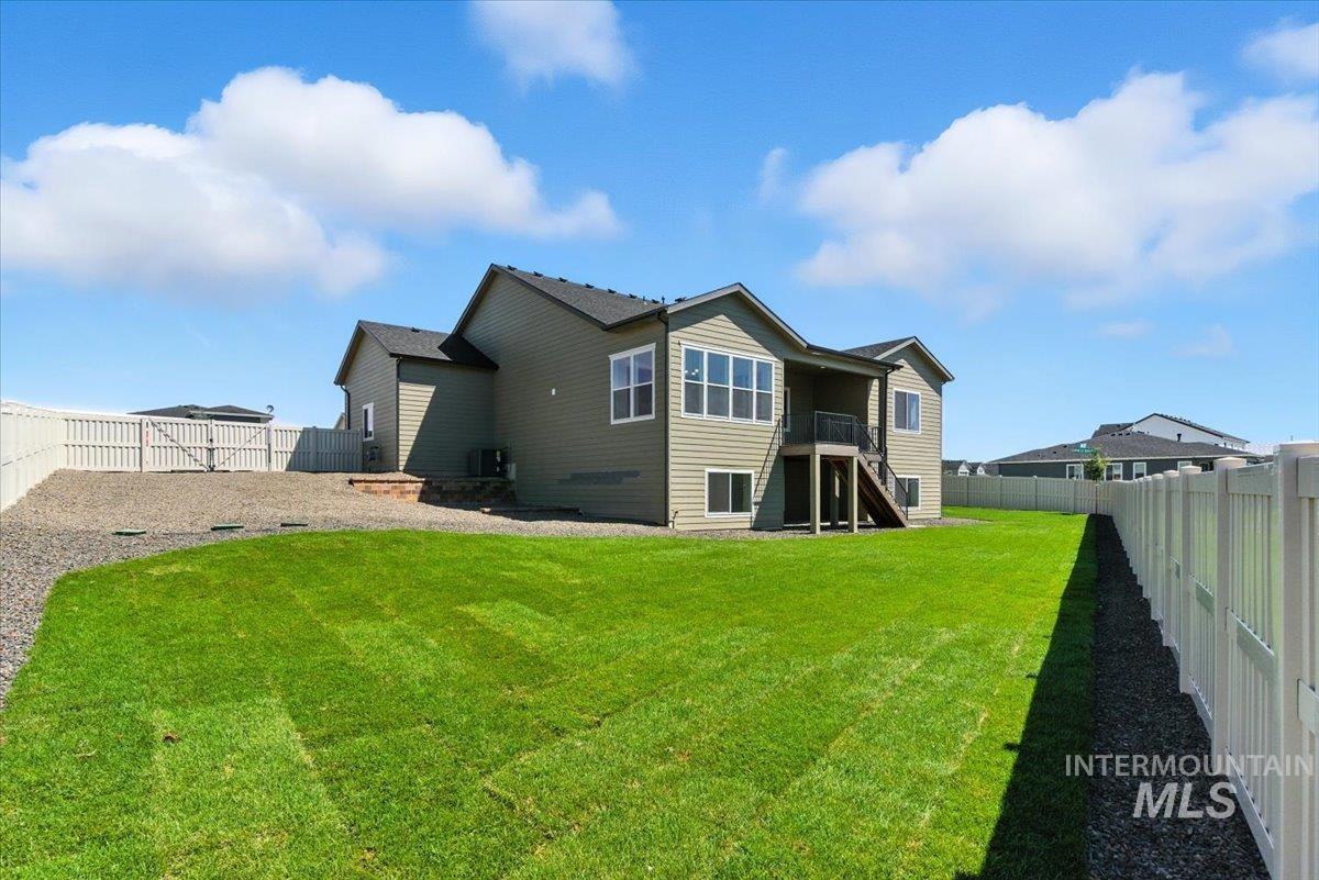 1275 Stirling Mdws Street Middleton, ID 83644 - Photo 40 of 42 Rear view of house with stairs and a fenced backyard