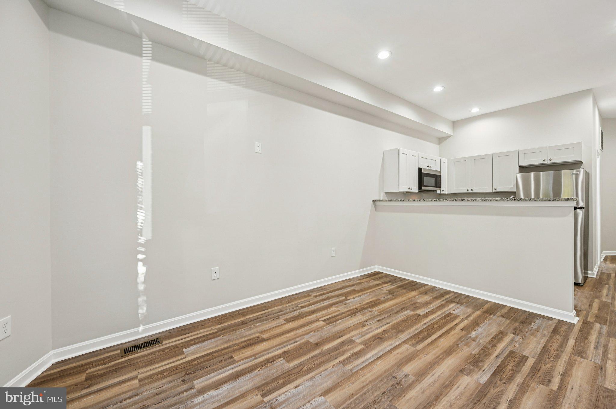 750 Reservoir Street, Unit A Baltimore, MD 21217 - Photo 11 of 23 a view of a kitchen with wooden floor and cabinets