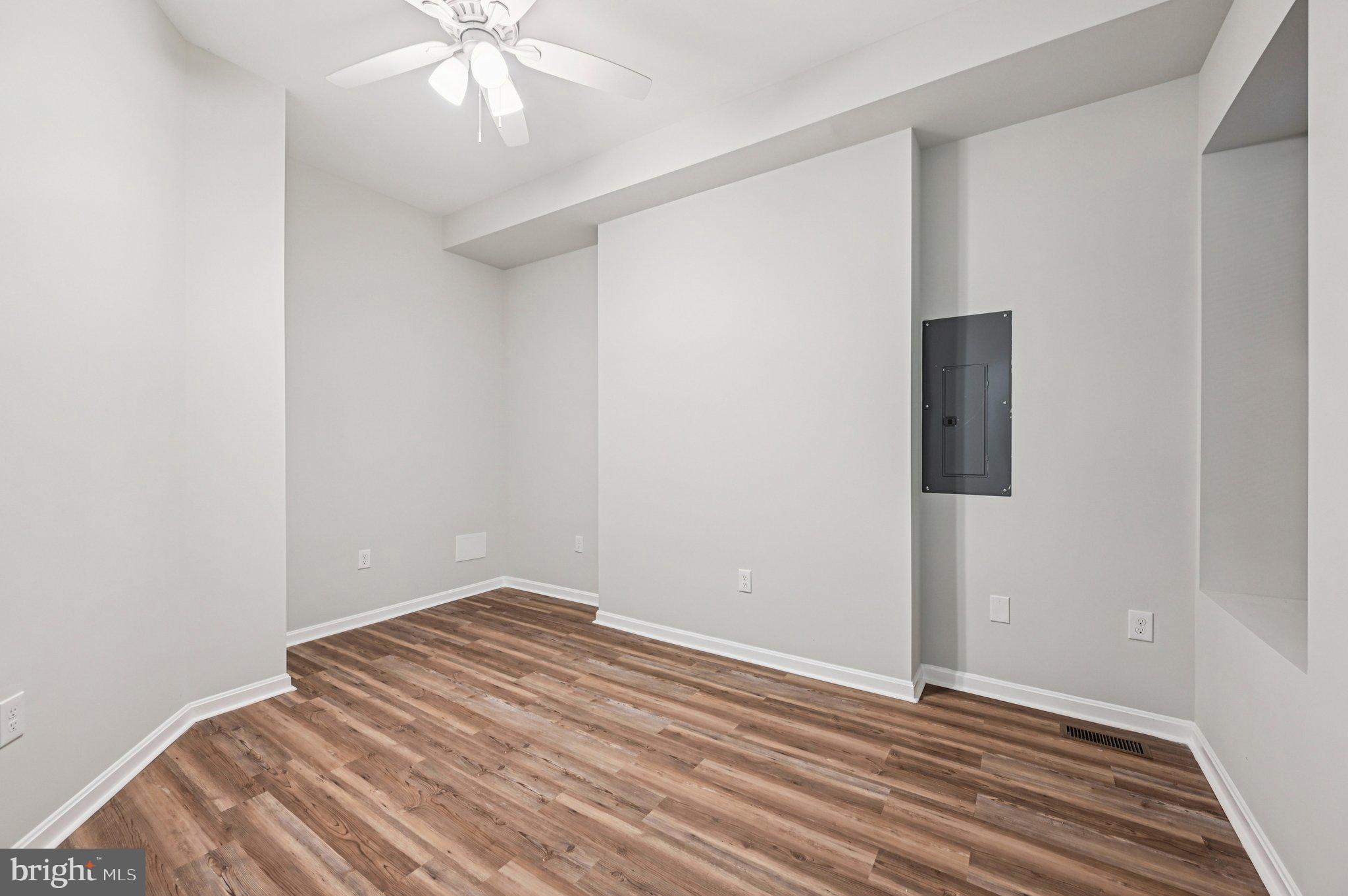 750 Reservoir Street, Unit A Baltimore, MD 21217 - Photo 17 of 23 an empty room with wooden floor and fan