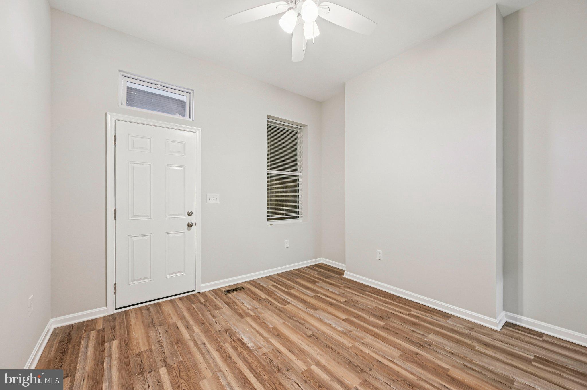 750 Reservoir Street, Unit A Baltimore, MD 21217 - Photo 21 of 23 a view of a room with wooden floor and a ceiling fan