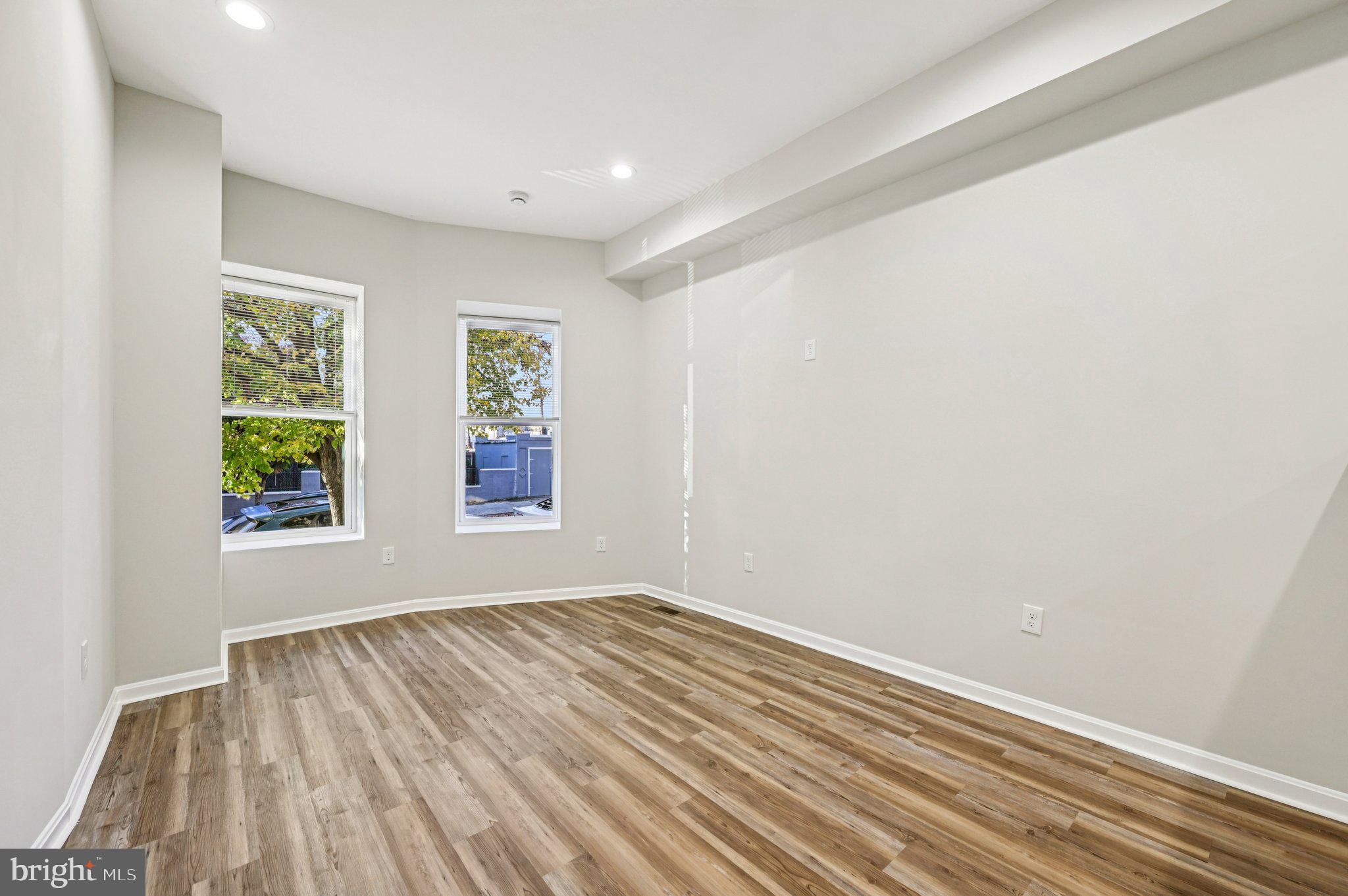 750 Reservoir Street, Unit A Baltimore, MD 21217 - Photo 8 of 23 a view of an empty room with wooden floor and a window
