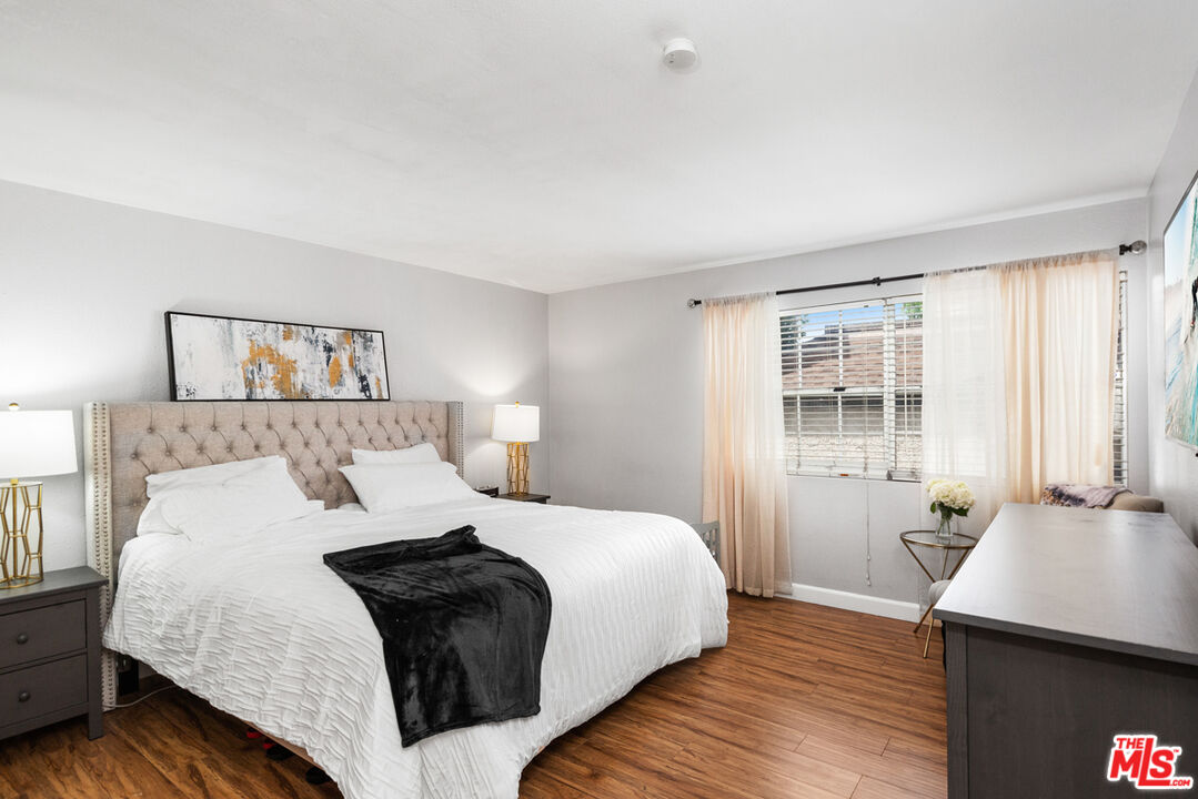 3800 Stocker Street, Unit 23 View Park, CA 90008 - Photo 13 of 33 a bedroom with a bed and wooden floor