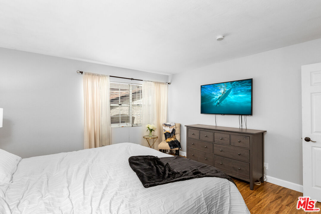 3800 Stocker Street, Unit 23 View Park, CA 90008 - Photo 14 of 33 a bedroom with a bed and a flat screen tv