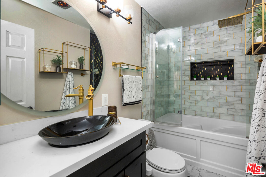 3800 Stocker Street, Unit 23 View Park, CA 90008 - Photo 16 of 33 a bathroom with a sink a toilet and bathtub
