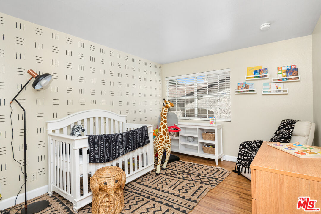 3800 Stocker Street, Unit 23 View Park, CA 90008 - Photo 17 of 33 a bedroom with furniture and baby crib