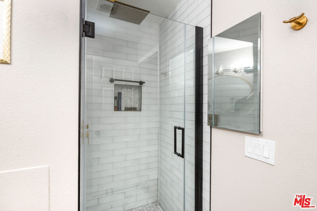 3800 Stocker Street, Unit 23 View Park, CA 90008 - Photo 19 of 33 a bathroom with a shower and a mirror