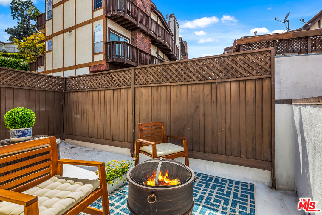 3800 Stocker Street, Unit 23 View Park, CA 90008 - Photo 25 of 33 a backyard of a house with barbeque oven table and chairs