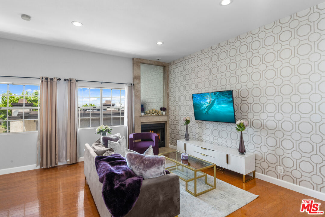 3800 Stocker Street, Unit 23 View Park, CA 90008 - Photo 3 of 33 a living room with furniture and a flat screen tv