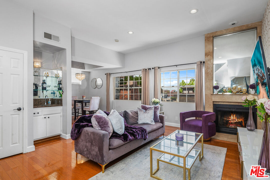 3800 Stocker Street, Unit 23 View Park, CA 90008 - Photo 4 of 33 a living room with furniture fireplace and a large window