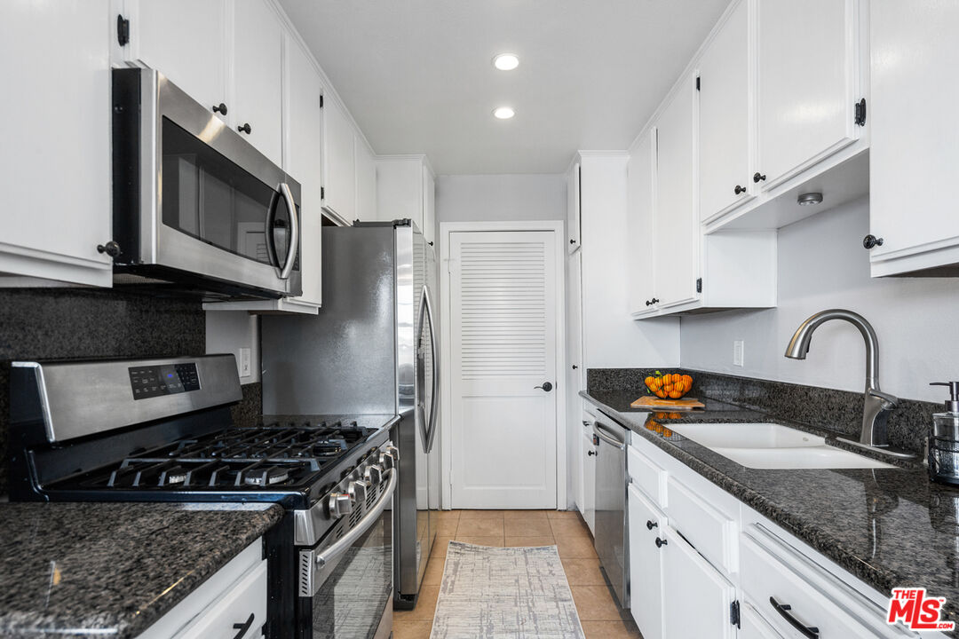 3800 Stocker Street, Unit 23 View Park, CA 90008 - Photo 7 of 33 a kitchen with stainless steel appliances granite countertop a stove a sink dishwasher and a refrigerator