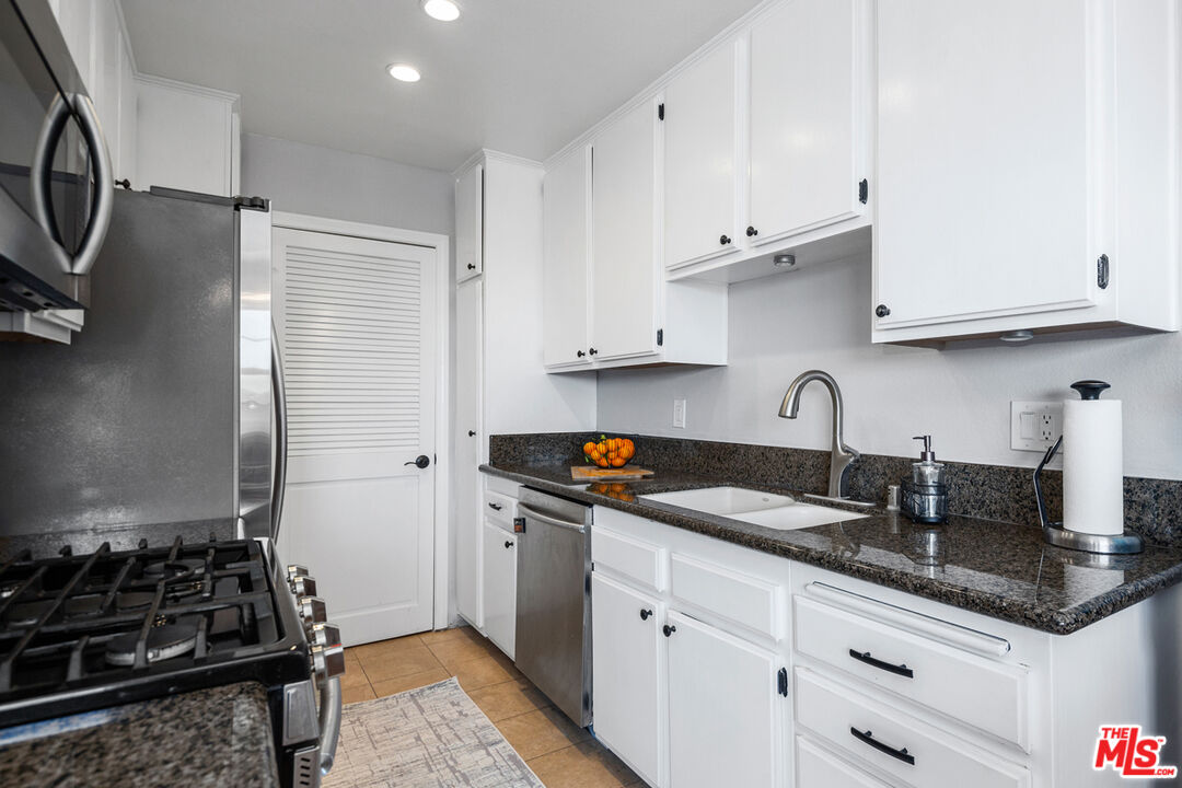 3800 Stocker Street, Unit 23 View Park, CA 90008 - Photo 8 of 33 a kitchen with granite countertop a sink stove and cabinets