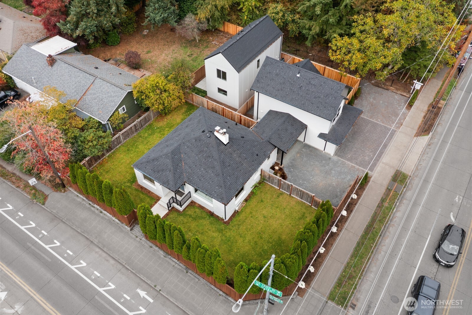 an aerial view of a house with garden space and parking