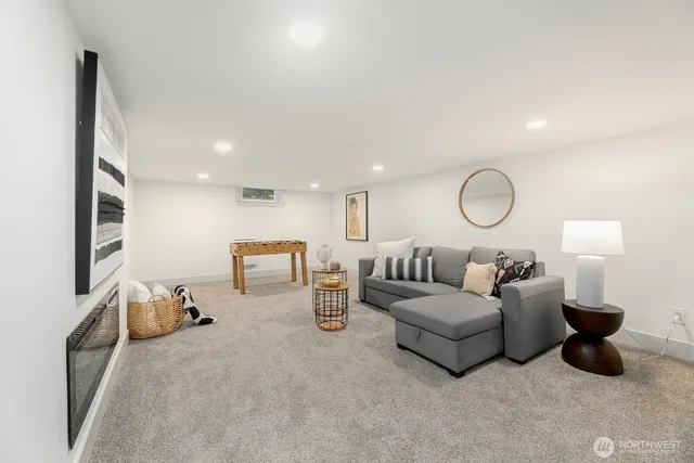 a living room with furniture and a mirror