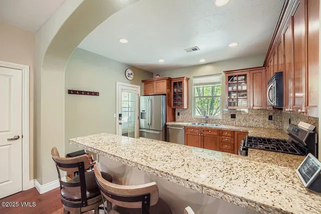 a kitchen with a stove a sink and a refrigerator