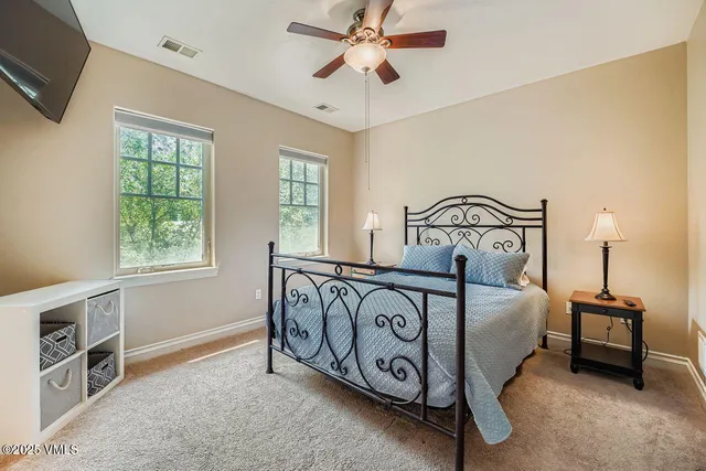 a bedroom with a bed and a tv