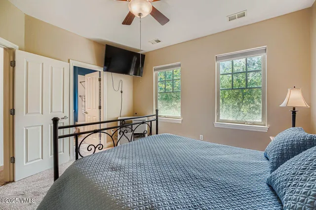 a bedroom with a large bed and a window