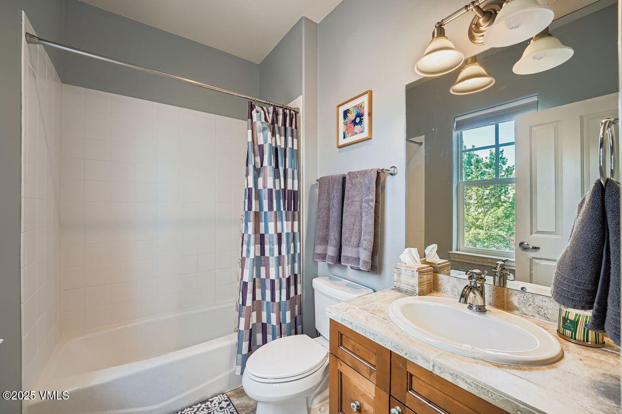 270 Founders Avenue Eagle, CO 81631 - Photo 22 of 28 a bathroom with a granite countertop bathtub sink vanity mirror and toilet