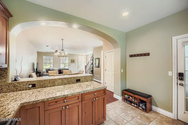 a bathroom with a granite countertop sink a mirror and a shower