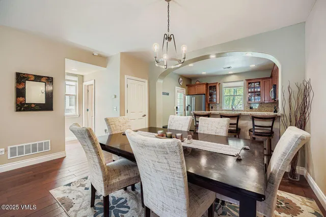 a view of a dining room with furniture wooden floor and chandelier