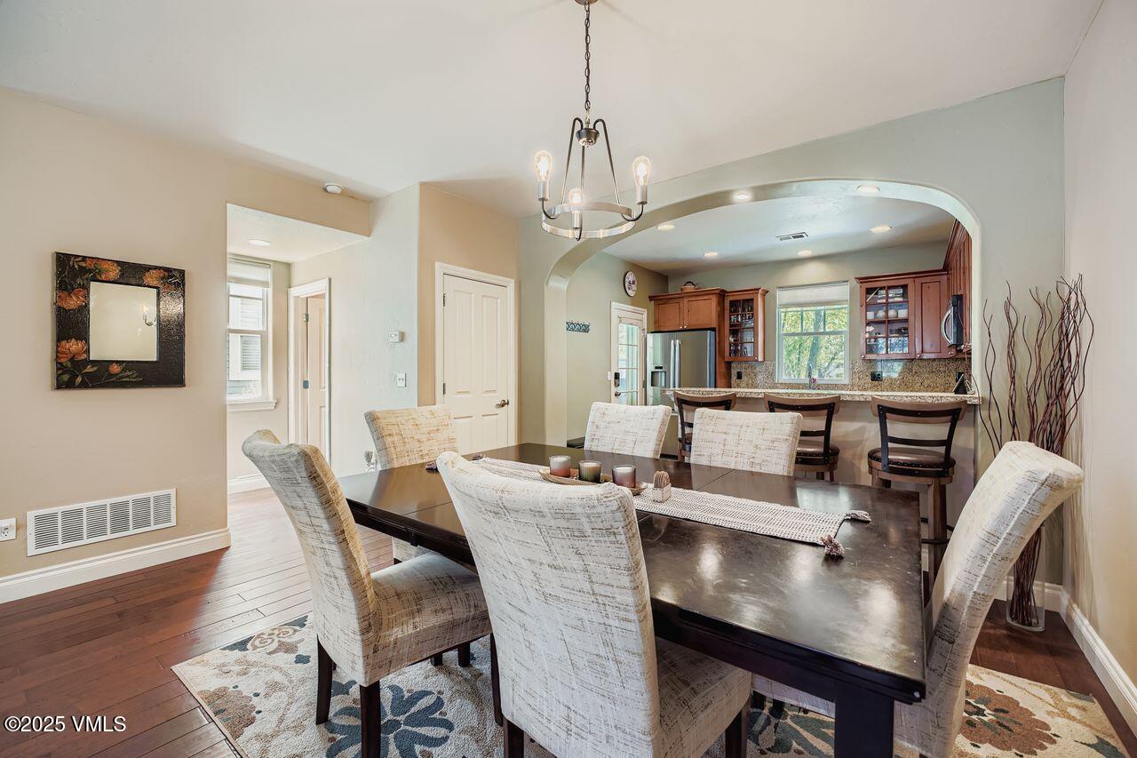 270 Founders Avenue Eagle, CO 81631 - Photo 9 of 28 a view of a dining room with furniture wooden floor and chandelier
