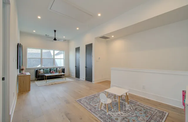 a living room with furniture and a refrigerator