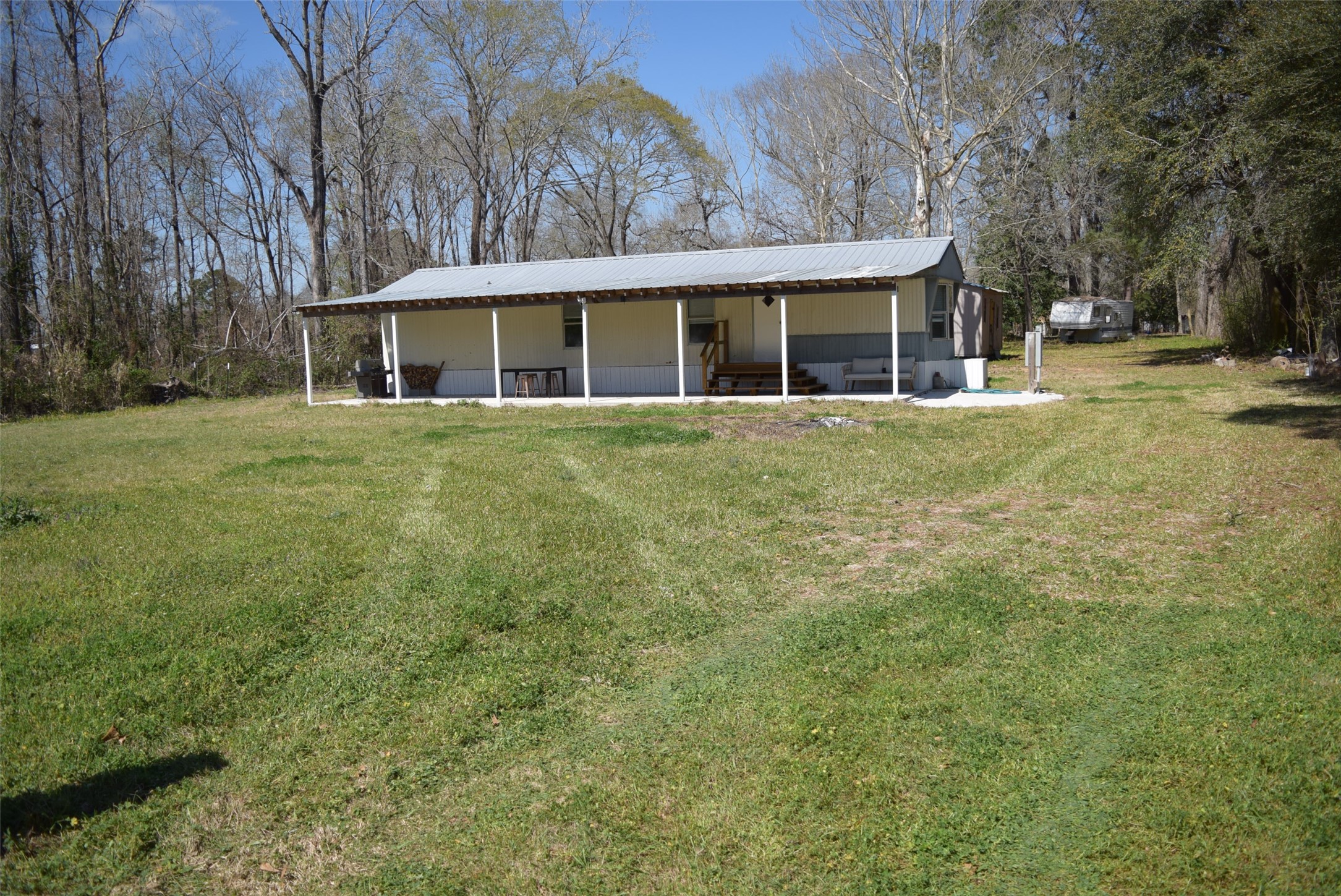 161 Irene Street Shepherd, TX 77371 - Photo 1 of 27 a front view of a house with a garden