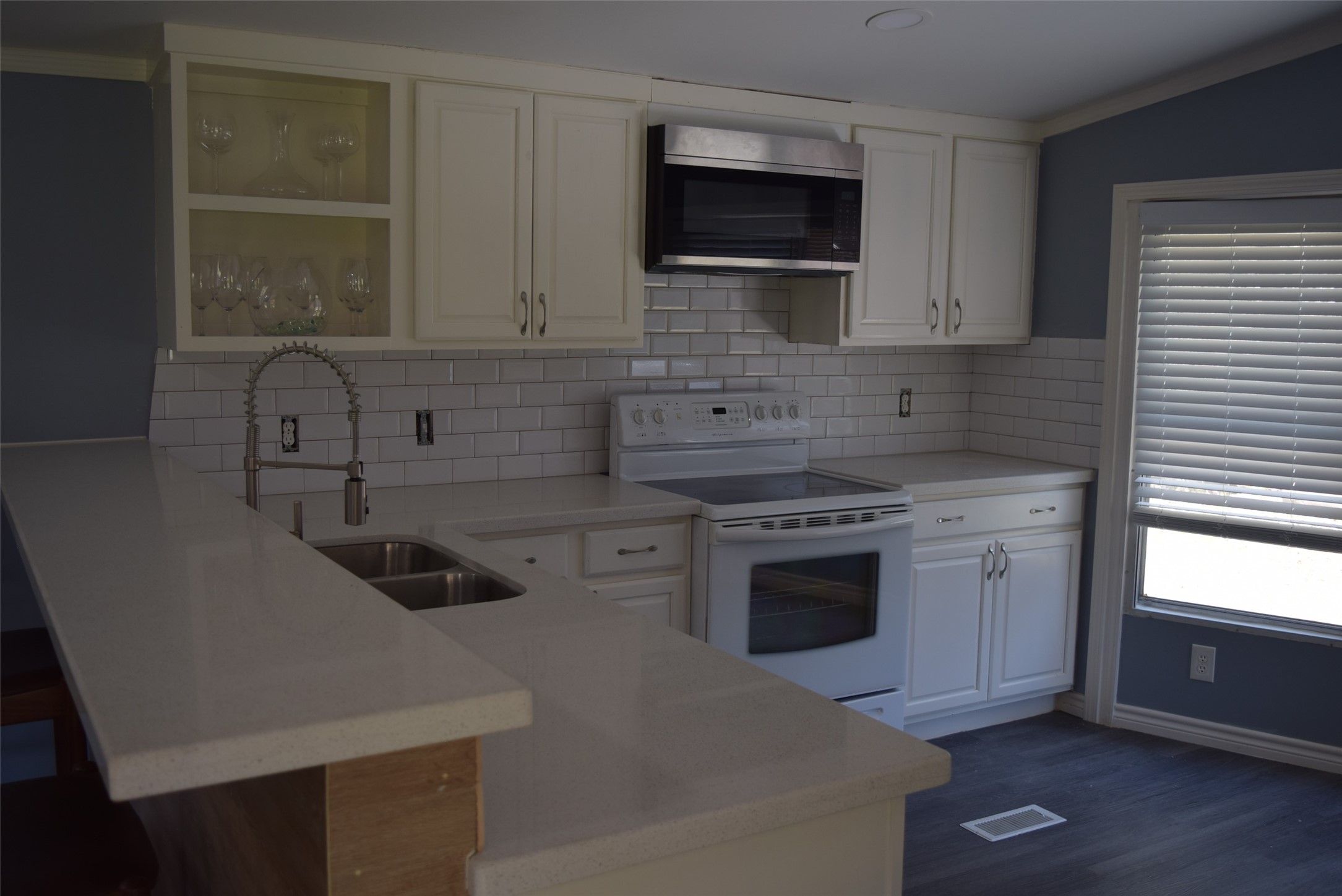 161 Irene Street Shepherd, TX 77371 - Photo 11 of 27 a kitchen with stainless steel appliances a stove sink microwave and cabinets