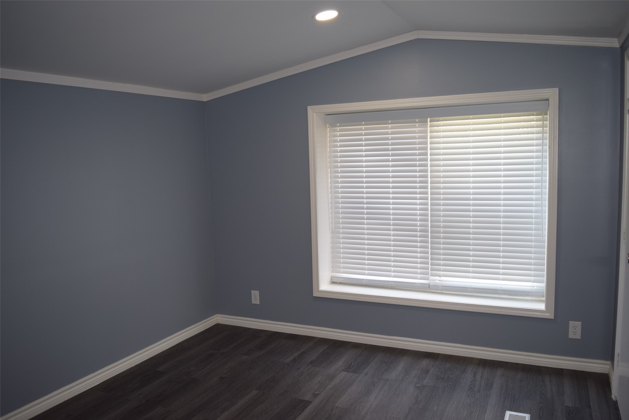 161 Irene Street Shepherd, TX 77371 - Photo 17 of 27 a view of an empty room with wooden floor and a window