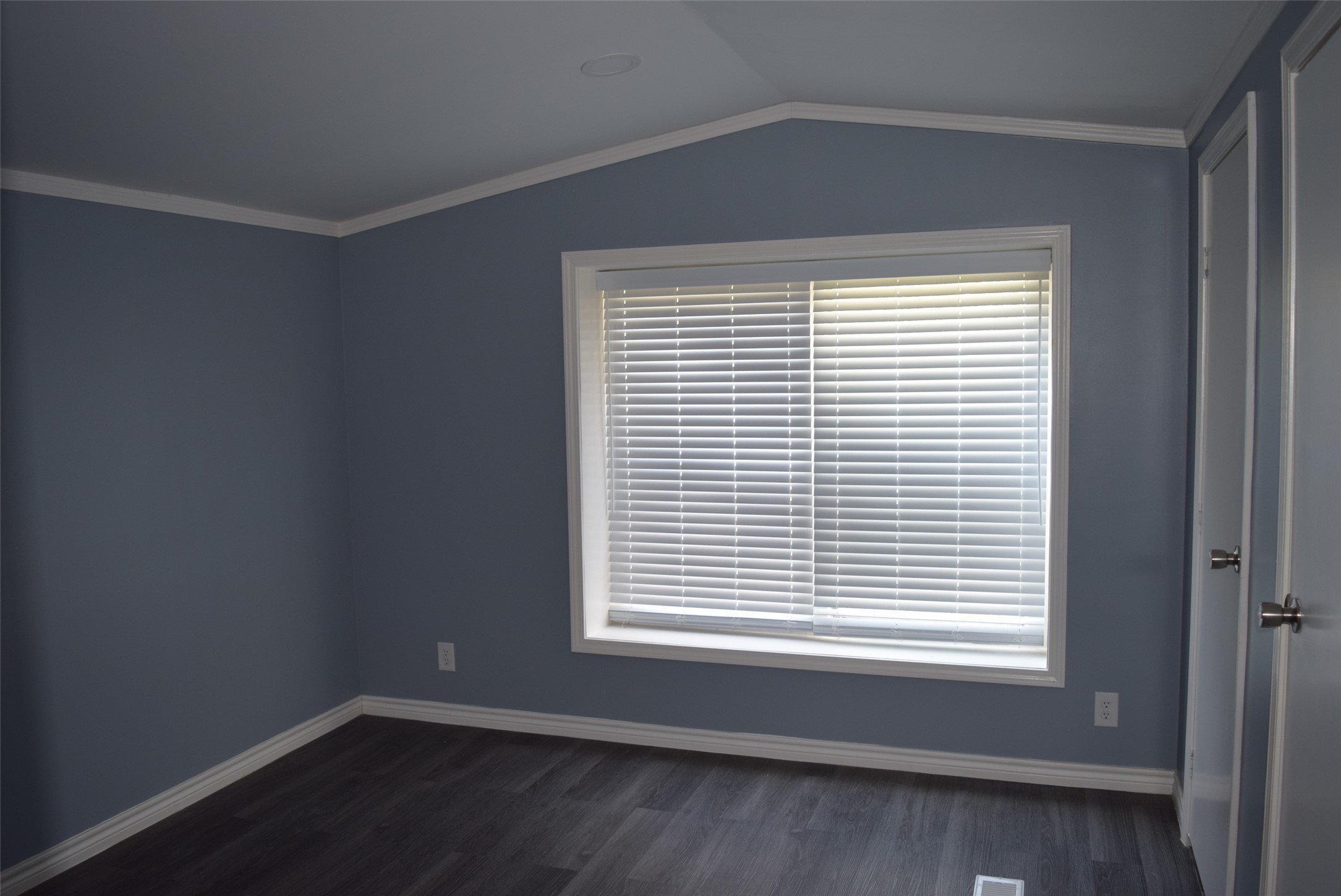 161 Irene Street Shepherd, TX 77371 - Photo 18 of 27 a view of an empty room with wooden floor and a window