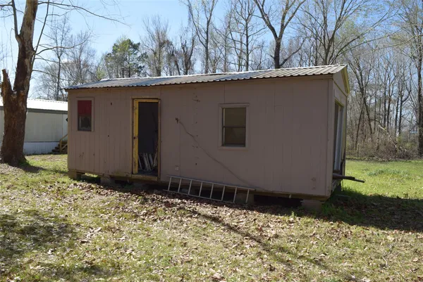 a side view of a house with a yard
