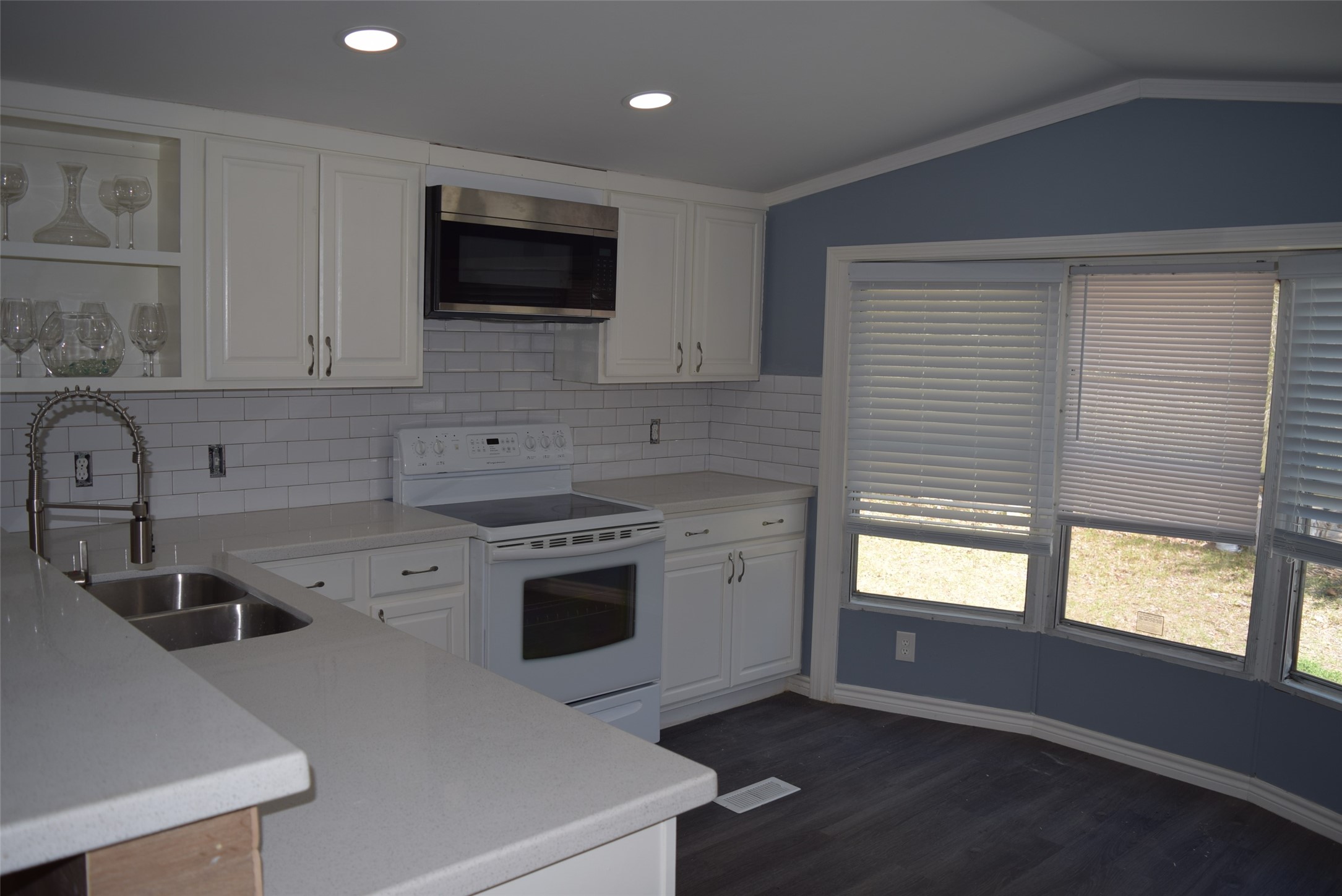 161 Irene Street Shepherd, TX 77371 - Photo 7 of 27 a kitchen with a sink a stove and microwave