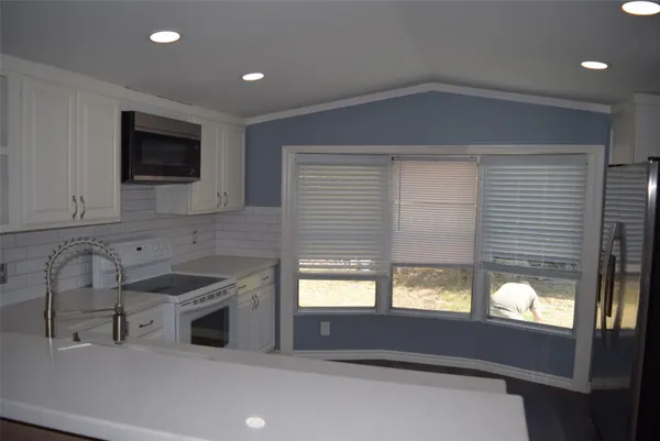 a kitchen with a sink and a window