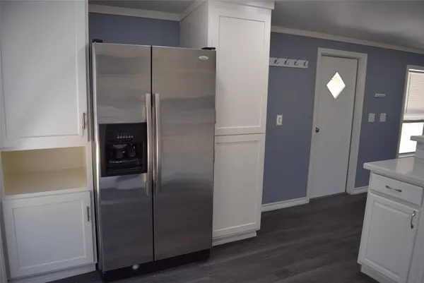 a kitchen with a refrigerator and a sink