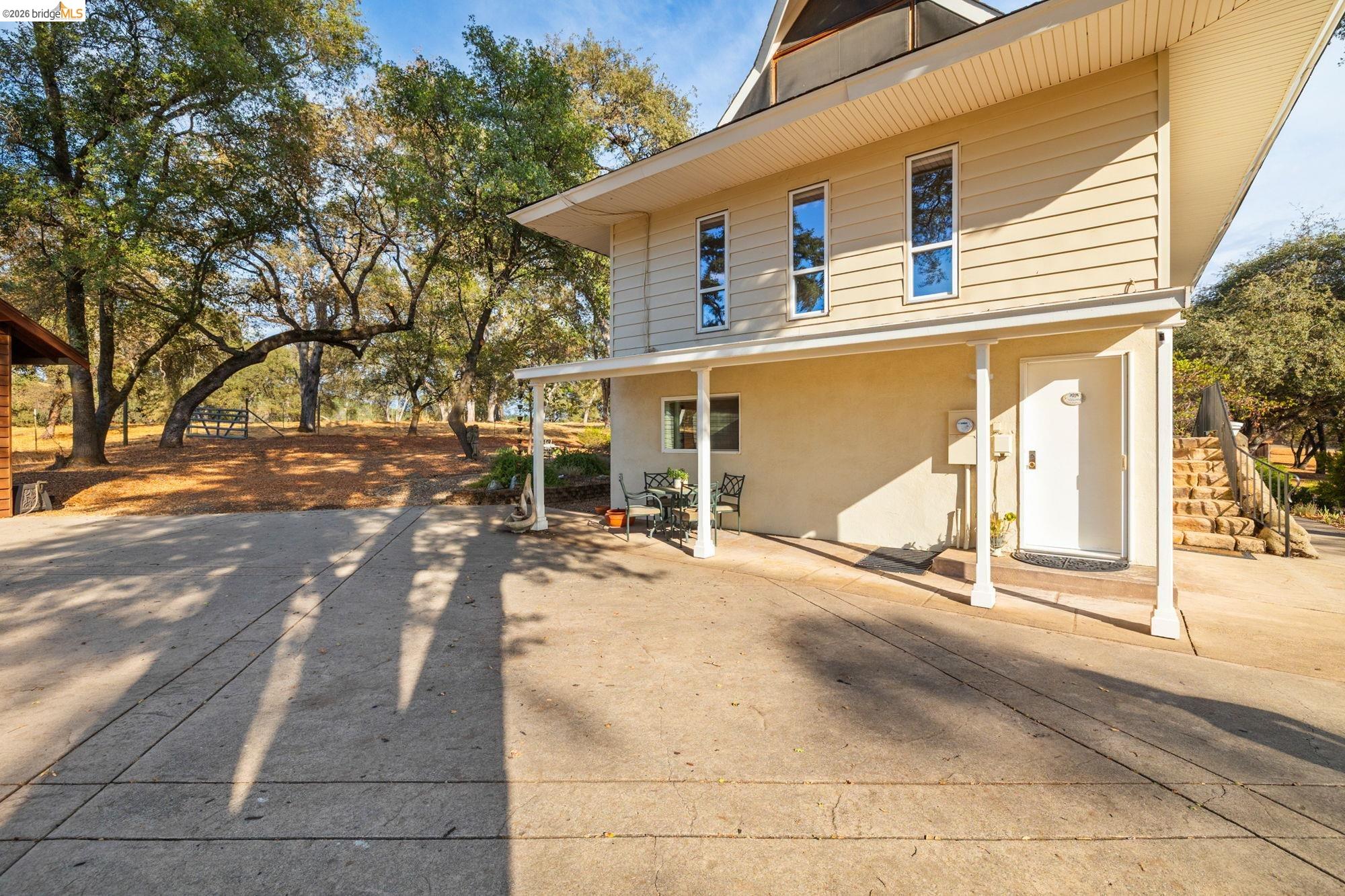 10566 Thistle Down Road Jamestown, CA 95327 - Photo 39 of 53 Back of house with stucco siding and a patio area