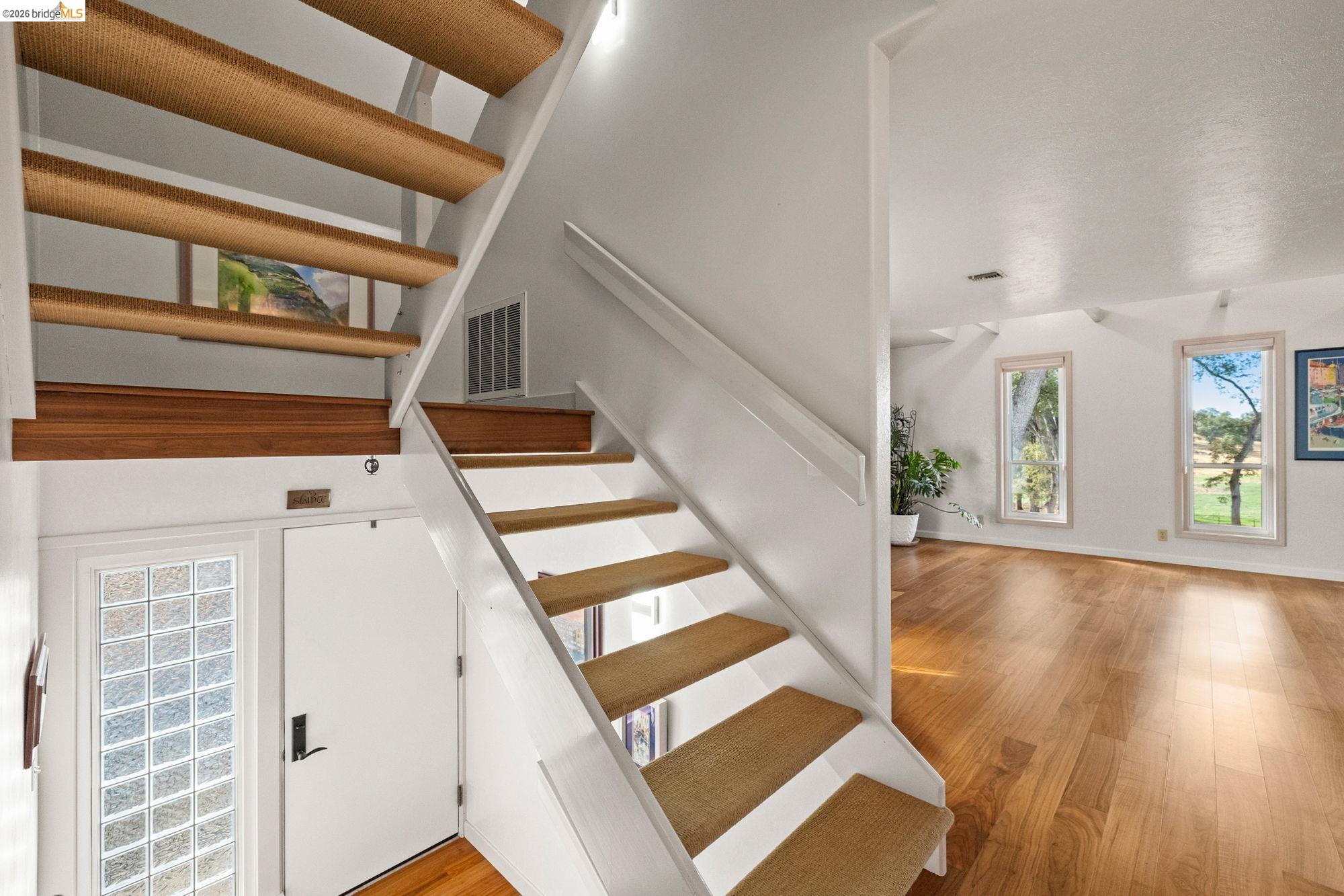 10566 Thistle Down Road Jamestown, CA 95327 - Photo 5 of 53 Stairs with wood finished floors and a high ceiling